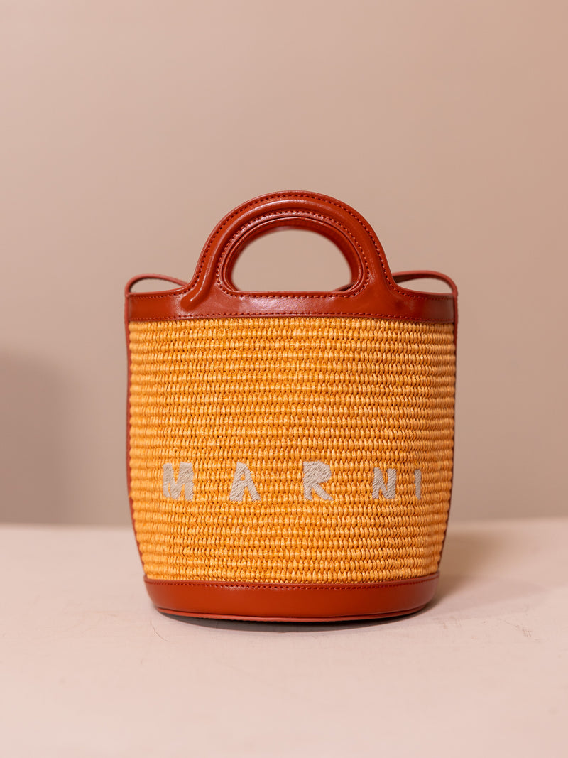 Orange bucket back against pink background.