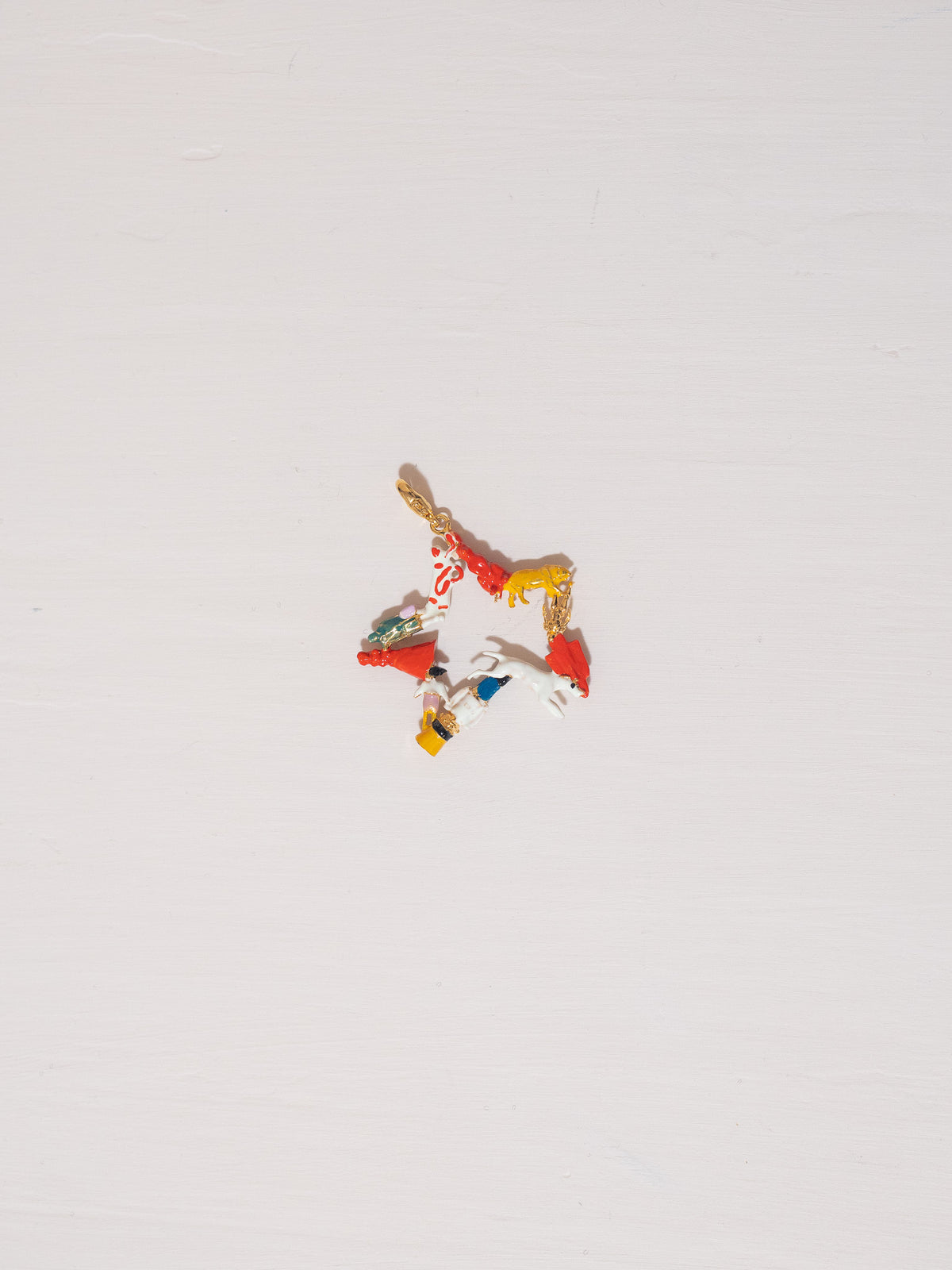 Colorful star-shaped earring on a light gray background
