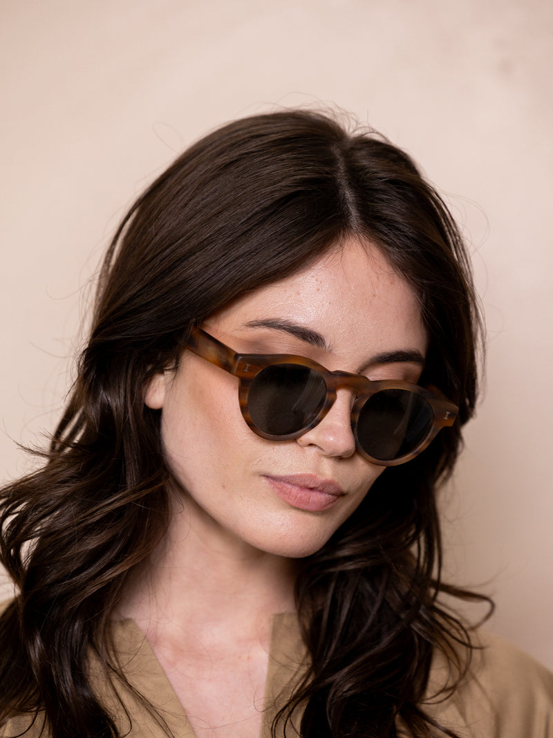 Woman wearing brown sunglasses.