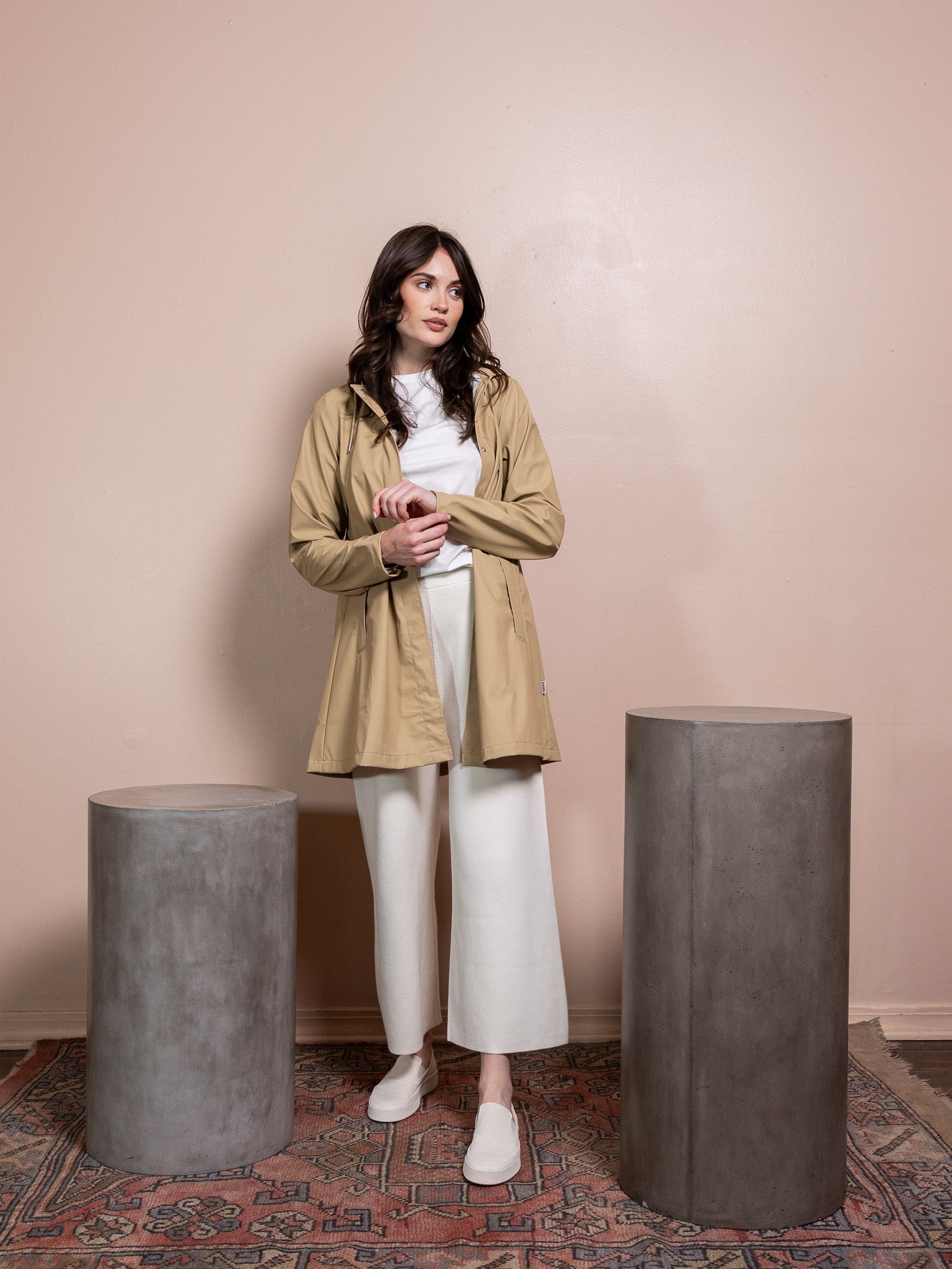 Woman in tan rain coat