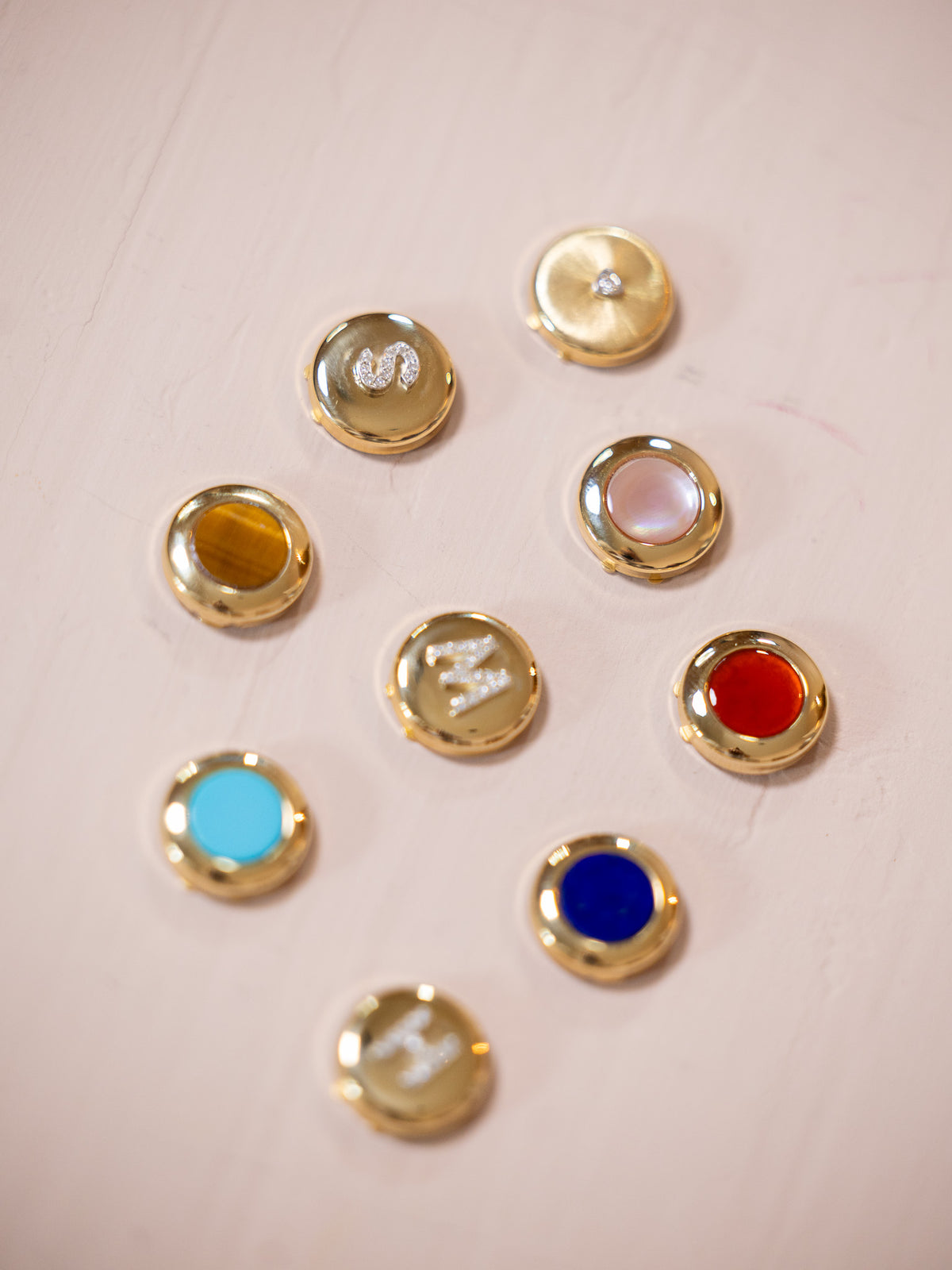 Various button covers on pink background