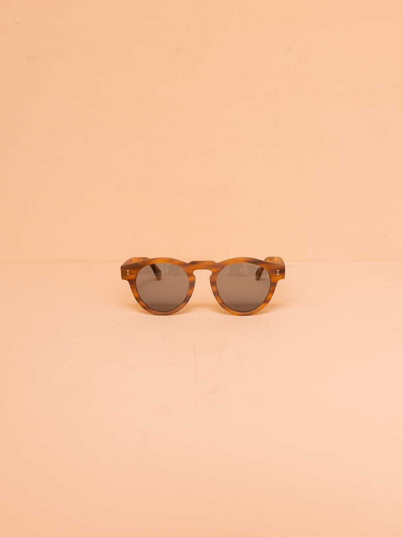 Brown sunglasses against pink background