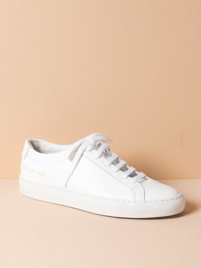Common Projects white sneaker with white laces and gold embossed numbers on the side. Achilles Low Sneaker in White. Style Number: 3701