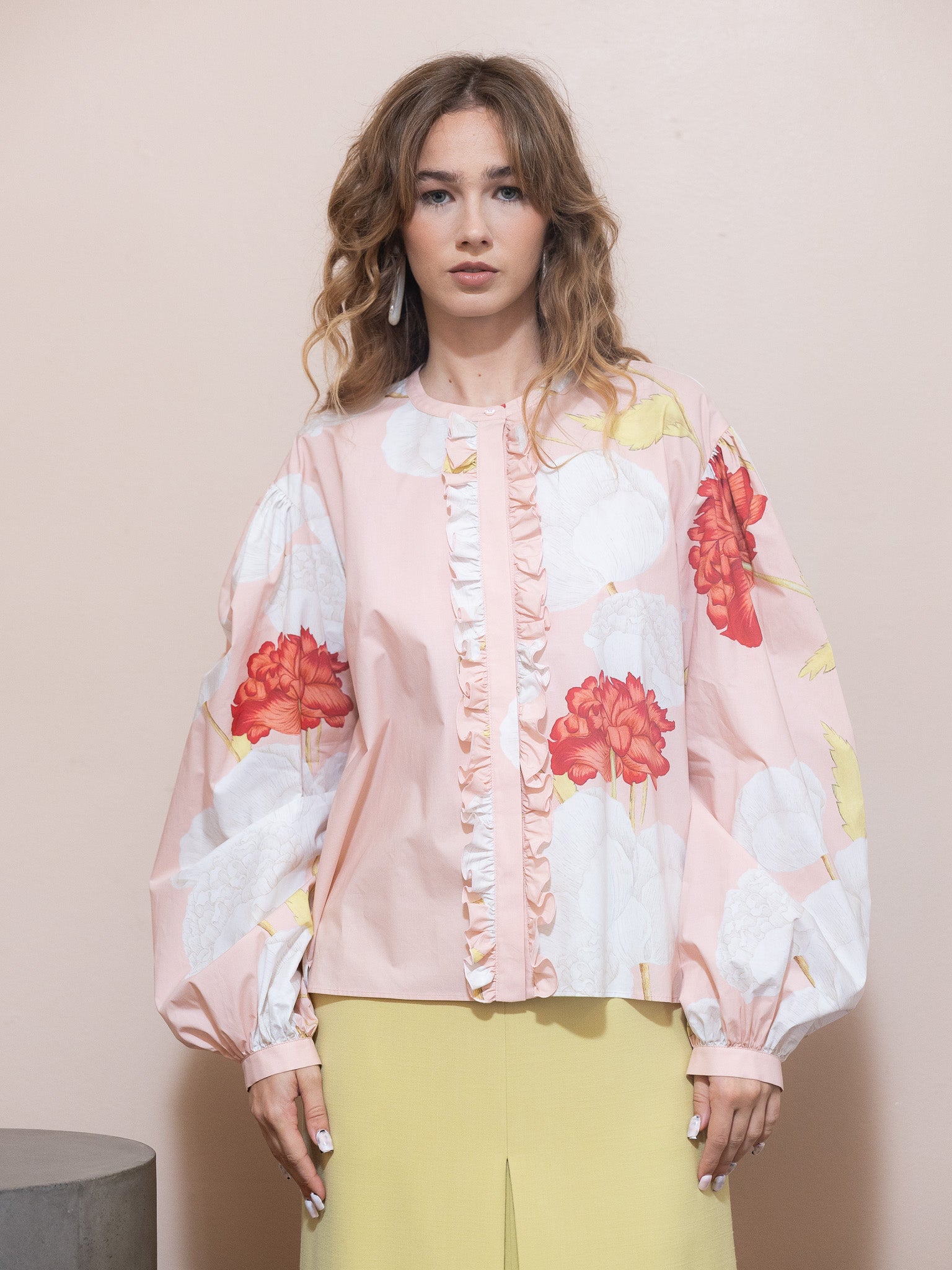 Woman wearing a floral blouse with a plain background