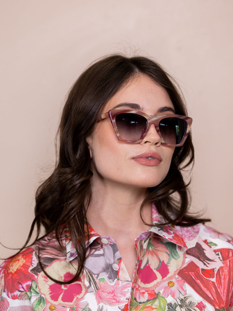 Woman wearing pink angular sunglasses