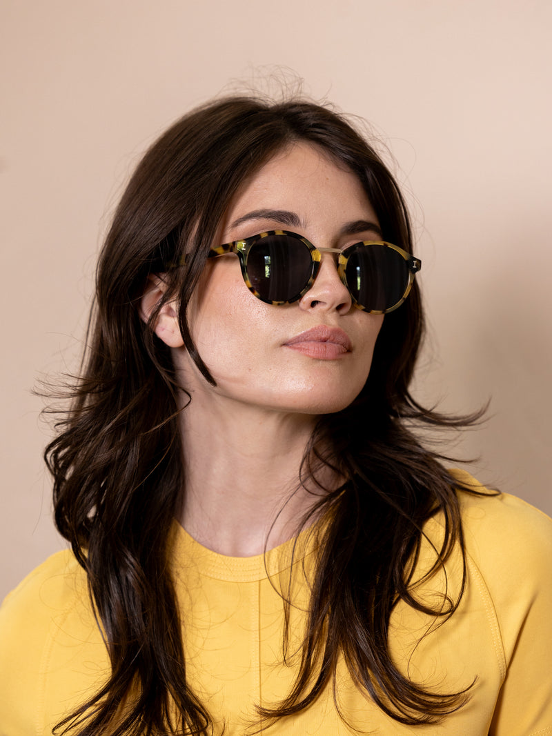 Woman wearing tortoiseshell sunglasses.