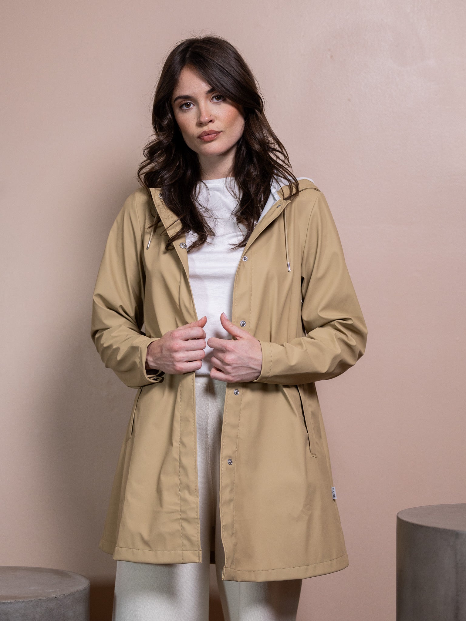 Woman in tan rain coat