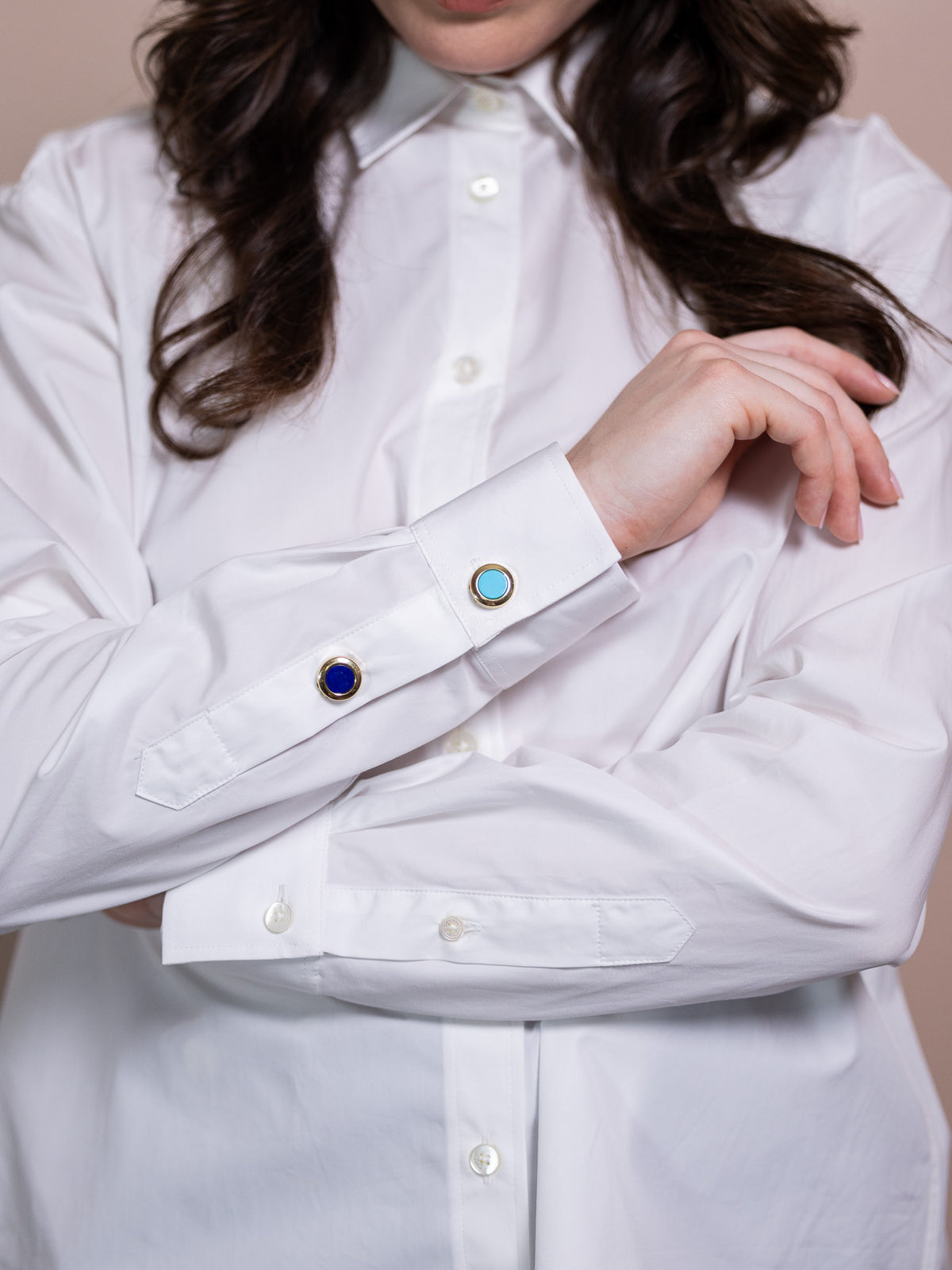 Lapus lazuli and gold button cover on white shirt.