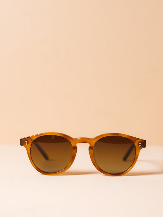 Chimi-03 Havana Core. Round. light brown sunglasses with light brown frames and two silver rivets at the front. 