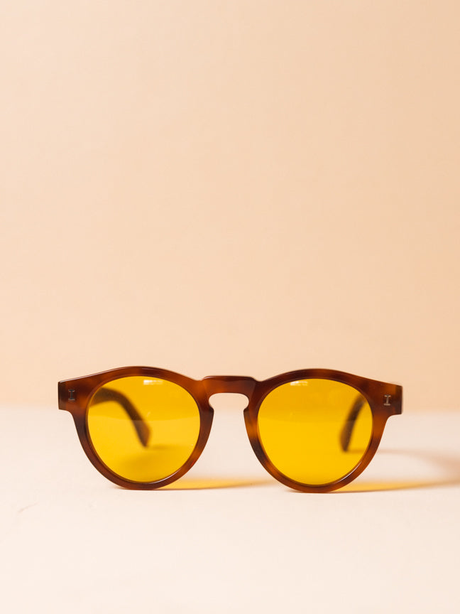Illesteva sunglasses with round brown frames and yellow lenses, with a raised nose bridge. Illesteva Leonard Sunglasses. Style Number: Style Number: ILLESTEVA-L-57HS