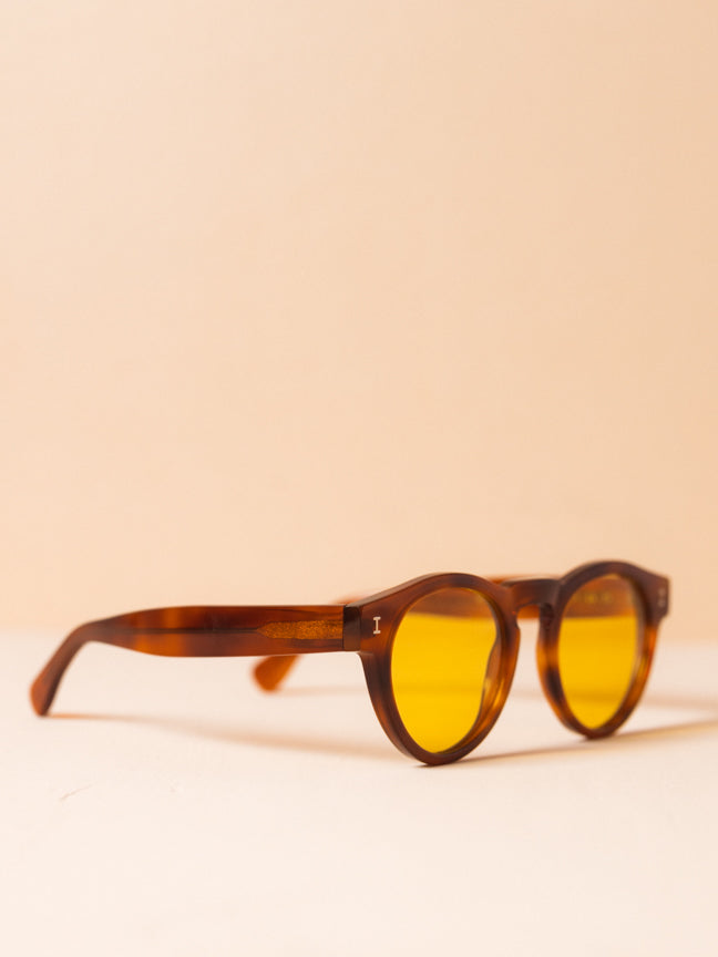 Side view of Illesteva sunglasses with round brown frames and yellow lenses, with a raised nose bridge. Illesteva Leonard Sunglasses. Style Number: Style Number: ILLESTEVA-L-57HS