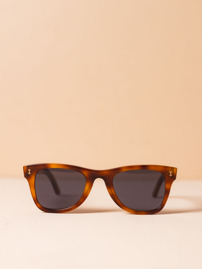 Illesteva lightly angled square framed sunglasses with brown tortoiseshell frames and dark gray lenses. Illesteva Austin sunglasses in red havana. Style Number: ILLESTEVA-AUS2F